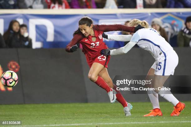 Christen Press of United States is challenged by Laura Bassett of England during the USA Vs England SheBelieves Cup match at Red Bull Arena on March...