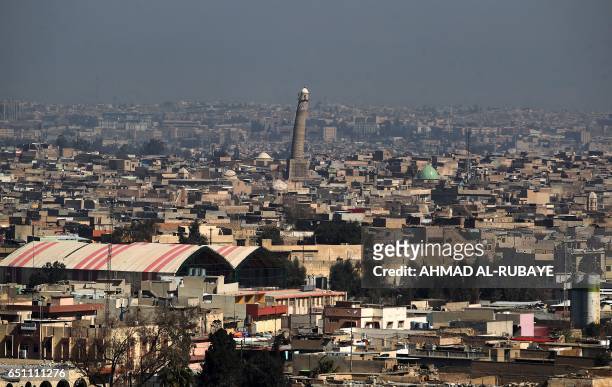 General view shows the leaning minaret of the Great Mosque of al-Nuri in Mosul, on March 10 as Iraqi forces shell enemy positions during an offensive...