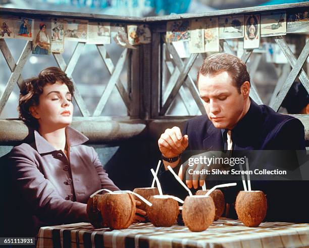 Actors Marlon Brando as Sky Masterson and Jean Simmons as Sarah Brown, sharing a few drinks in Havana in the musical film 'Guys and Dolls', 1955.