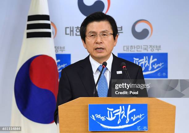 South Korean acting President and Prime Minister Hwang Kyo-ahn speaks to the nation during a press conference at the government complex on March 10,...