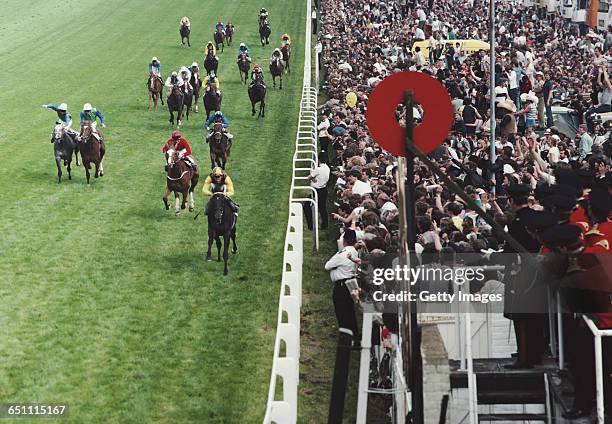 Lester Piggott of Great Britain riding Teenoso beats Carlingford Castle ridden by Mick Kinane into second place to win the 204th annual running of...