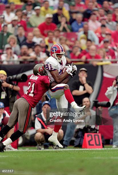 Peerless Price of the Buffalo Bills leaps up to make a catch against Donnie Abraham of the Tampa Bay Buccaneers during the game at the Raymond James...