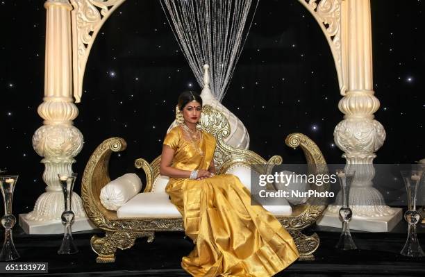 Indian fashion model wearing an elegant and ornate Kanchipuram saree during a South Asian bridal show held in Scarborough, Ontario, Canada.