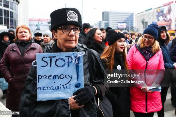 Woman with a banner participates in the Miedzynarodowy Strajk Kobiet on March 08, 2017 in Warsaw, Poland. IWS is an initiative established by womens...