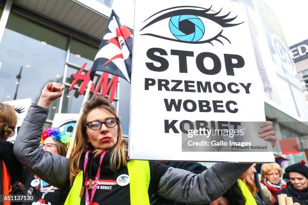 Woman with a banner participates in the Miedzynarodowy Strajk Kobiet on March 08, 2017 in Warsaw, Poland. IWS is an initiative established by womens...