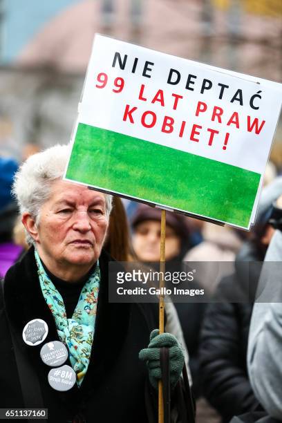Woman with a banner participates in the Miedzynarodowy Strajk Kobiet on March 08, 2017 in Warsaw, Poland. IWS is an initiative established by womens...