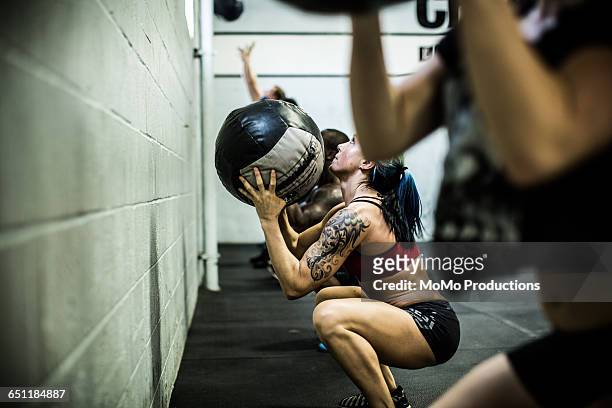 gym - class using medicine balls - crossfit training stock pictures, royalty-free photos & images
