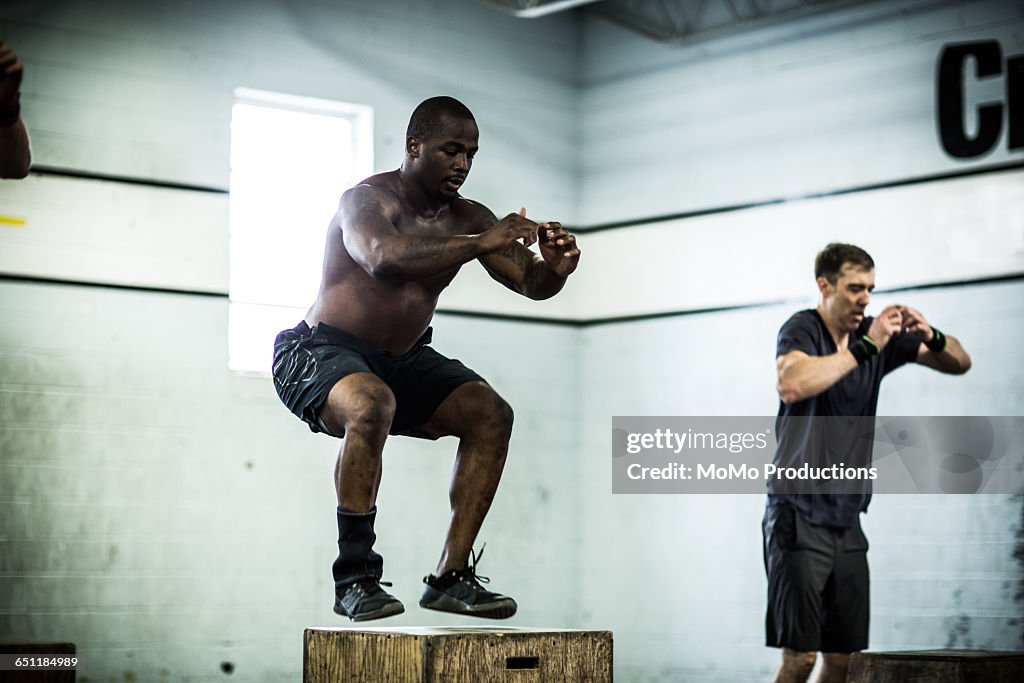 Gym - men doing box jumps