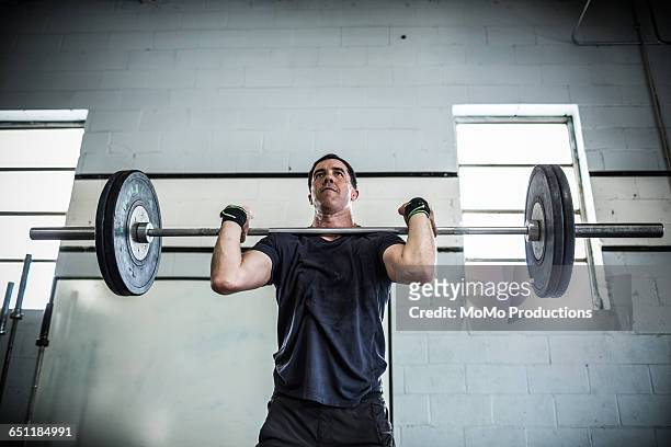 gym - man lifting weights