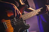 Close-up photo of bass guitar player