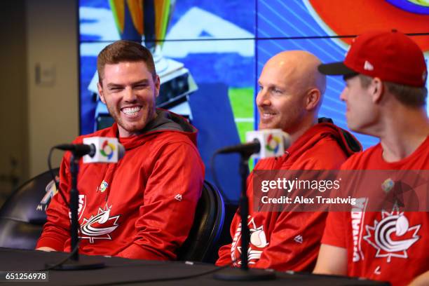 Freddie Freeman, Pete Orr, and Justin Morneau of Team Canada speak during the Pool C press conference for the World Baseball Classic on Thursday,...