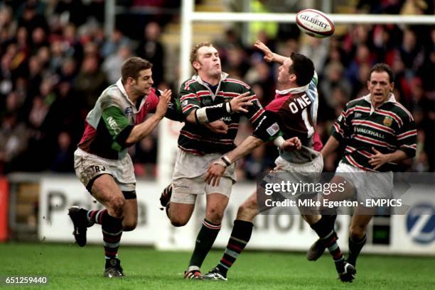 Leicester Tigers' Andy Goode passes the ball as NEC Harlequins' Rob Jewell and Ryan O'Neill converge on him