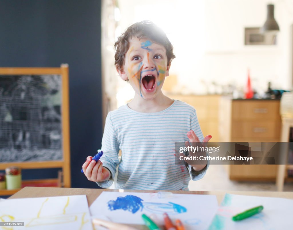 A boy playing with felt pens