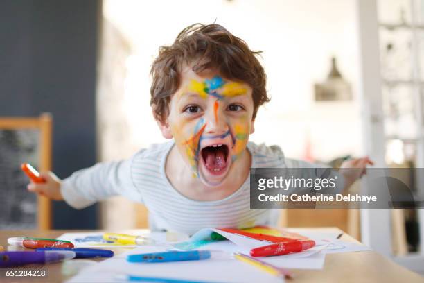 a boy playing with felt pens - misbehaving children stock pictures, royalty-free photos & images