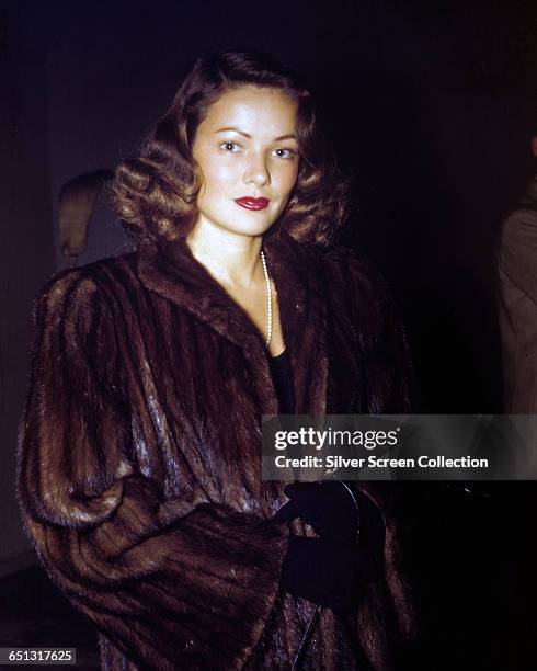 American actress Gene Tierney wearing a fur coat, circa 1945.