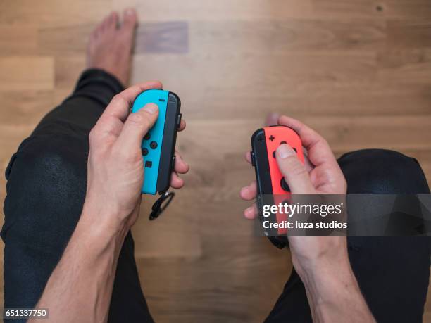 nintendo switch neon game controller - switch stock pictures, royalty-free photos & images