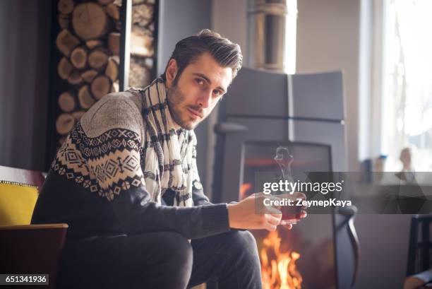 tea break - sitting by fireplace stock pictures, royalty-free photos & images