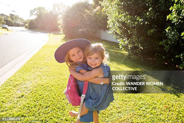 little girl and sister walking to school australia - first day of school australia stock pictures, royalty-free photos & images