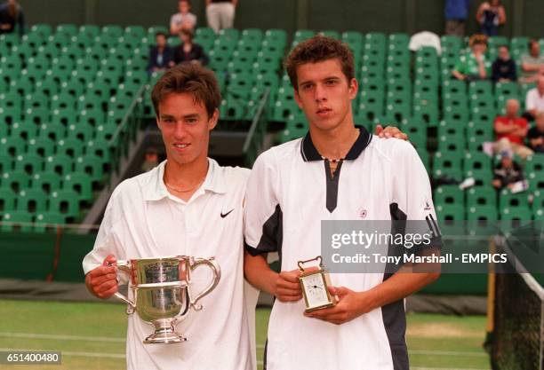 Switzerland's Roman Valent with trophy after winning the Wimbledon boys singles title, next to him in Gilles Muller who came runners-up