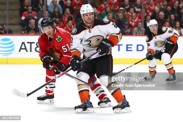 Chicago Blackhawks defenseman Brian Campbell and Anaheim Ducks defenseman Kevin Bieksa battle on the ice during the second period of a game between...