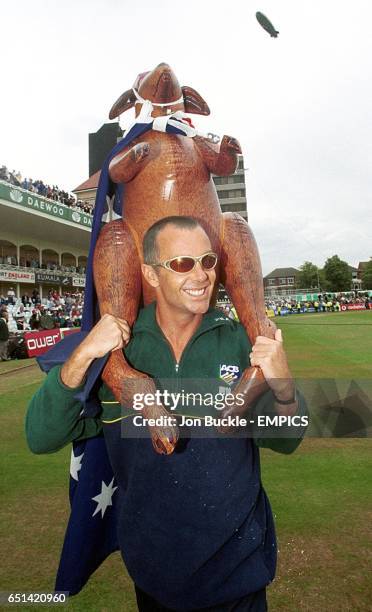 Australia's Colin Miller celebrates by carrying a inflatable kangaroo