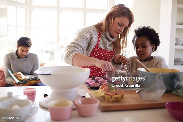 family baking cake in kitchen at home together - kitchen scale stock pictures, royalty-free photos & images