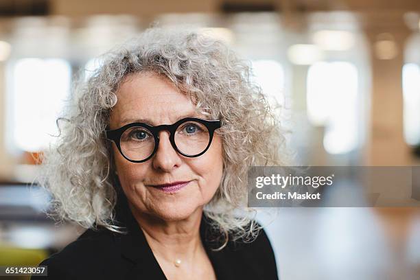 close-up portrait of smiling senior woman at corridor - 60 woman stock pictures, royalty-free photos & images