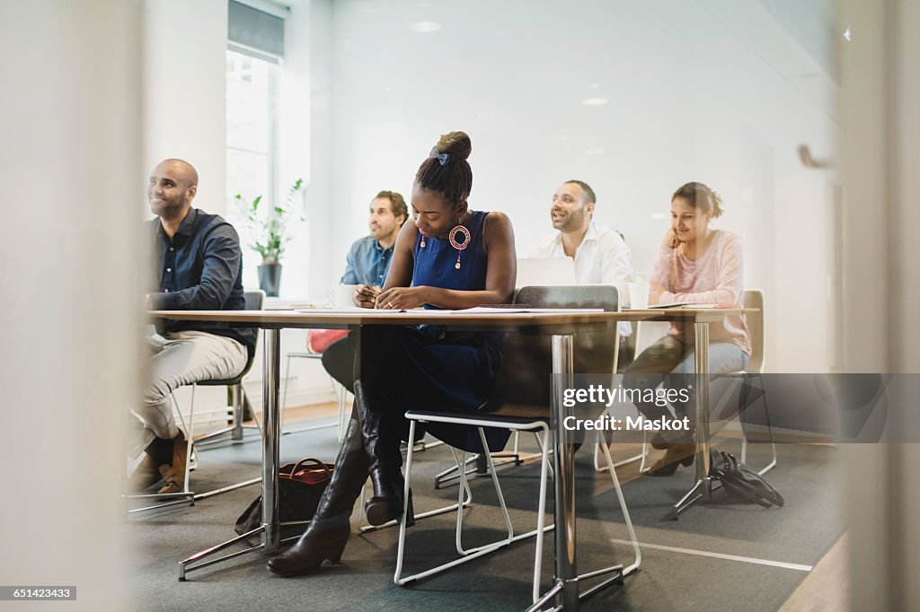 Students sitting in language class seen through glass