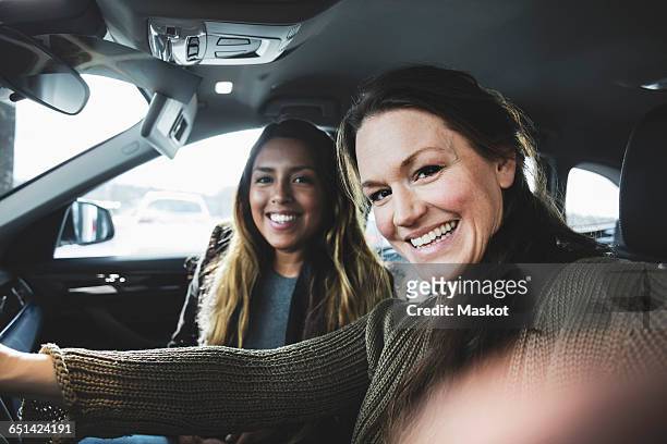 portrait of smiling friends sitting in car at showroom - new u s supreme court poses for class photo fotografías e imágenes de stock