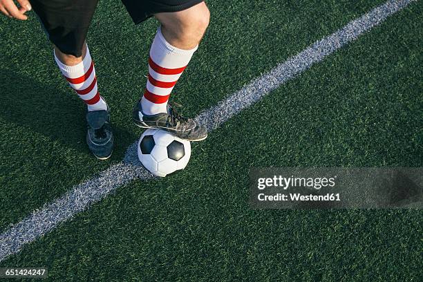 legs of football player with ball on football ground - kick off fotografías e imágenes de stock