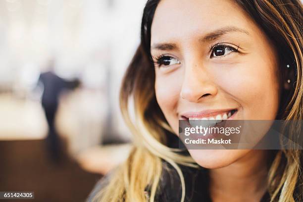 close-up of smiling young woman looking away - mèche foto e immagini stock