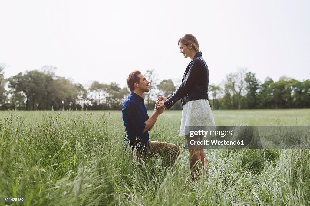 Man proposing marriage to young woman