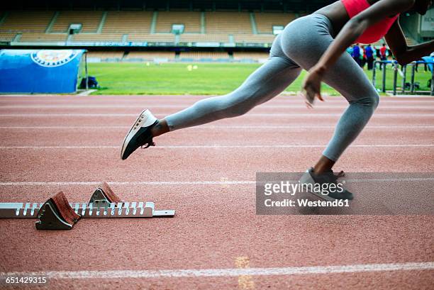 young black athlete starting at race in stadium - track starting block stock pictures, royalty-free photos & images