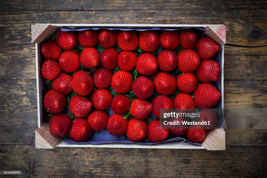 Wooden box with sorted strawberries