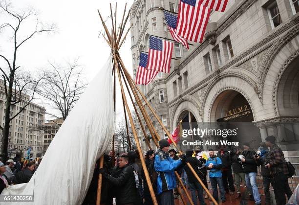 Activists erect a tipi outside the Trump International Hotel during a protest against the Dakota Access Pipeline March 10, 2017 in Washington, DC....