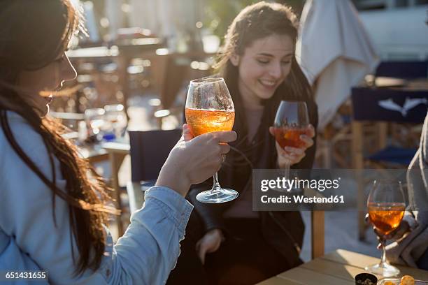 young women sitting in bar drinking aperitif - ladies night stock pictures, royalty-free photos & images