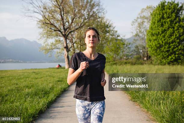 young woman running in the nature - frau wiese bewegt stock-fotos und bilder