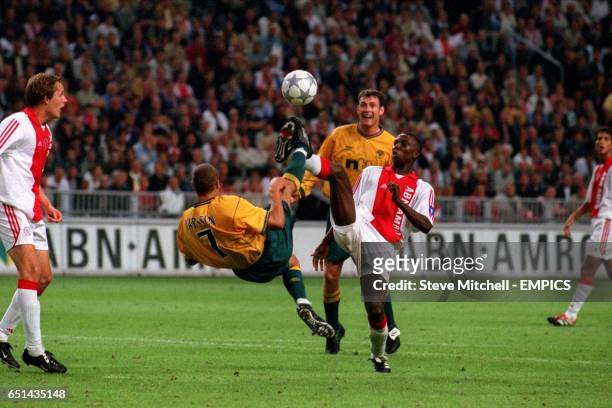 Ajax's Abubakari Yakubu and Celtic's Henrik Larsson both attempt overheads kicks