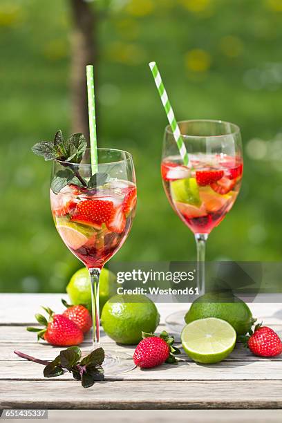 glasses with ice, strawberry, lime, grenadine and prosecco - prosecco stock pictures, royalty-free photos & images