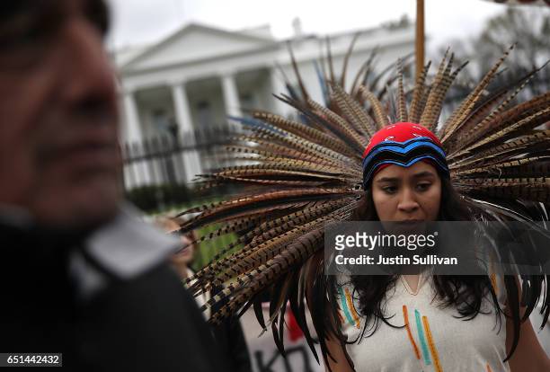 Native American stands in front of the White House during a demonstration against the Dakota Access Pipeline on March 10, 2017 in Washington, DC....