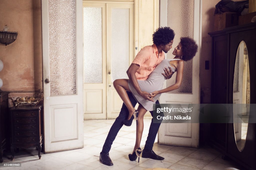 Romantic young couple dancing at home