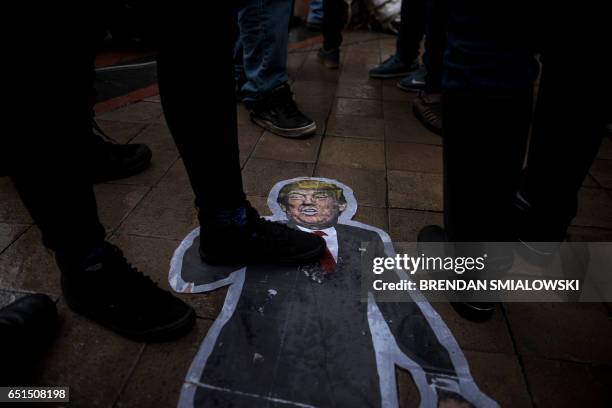 Cutout of US President Donald Trump is seen on the ground as activists rally in front of the Trump International Hotel to protest the Dakota Pipeline...