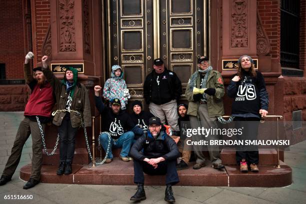 Activists gather protesting the Dakota Pipeline, chain themselves to a Sun Trust Bank during the Native Nations Rise protest March 10, 2017 in...