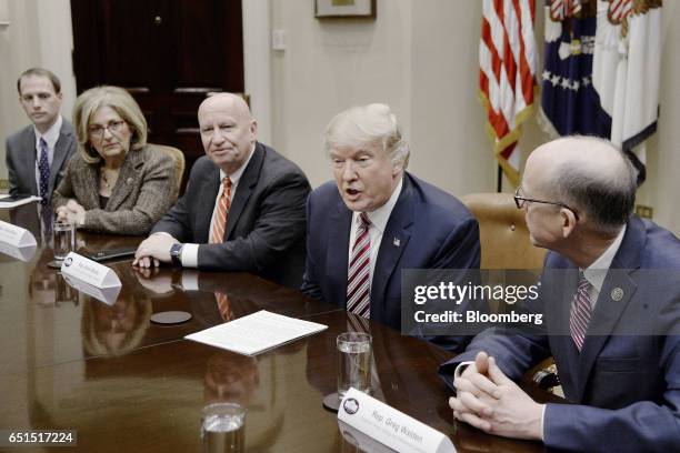 President Donald Trump, second right, speaks as Representative Greg Walden, a Republican from Oregon, right, and Representative Kevin Brady, a...