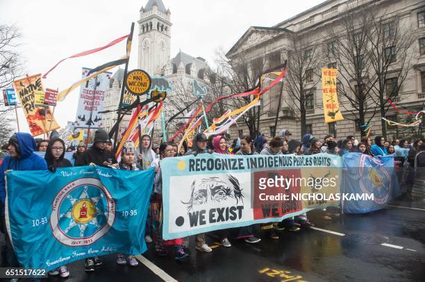 People march past Trump International Hotel during the Native Nations Rise protest on March 10, 2017 in Washington, DC. Native tribes from around the...