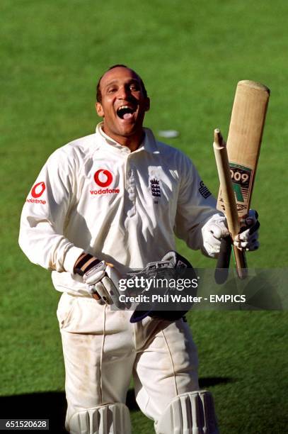 England's Mark Butcher is all smiles as he leaves the pitch with the stumps after leading his side to victory in the 4th ASHES with a total of 173...