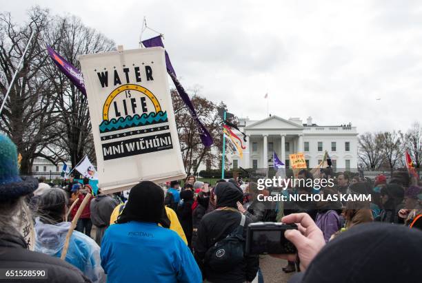 People gather in front of the White House during the Native Nations Rise protest on March 10, 2017 in Washington, DC. Native tribes from around the...