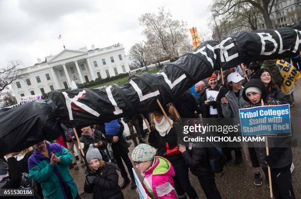 People gather in front of the White House during the Native Nations Rise protest on March 10, 2017 in Washington, DC. Native tribes from around the...