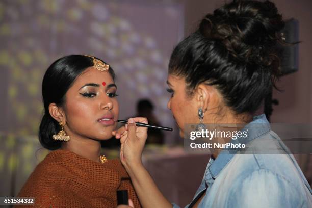 Make-up artist prepares an Indian fashion model to take part in a fashion show during a South Asian bridal show held in Scarborough, Ontario, Canada.