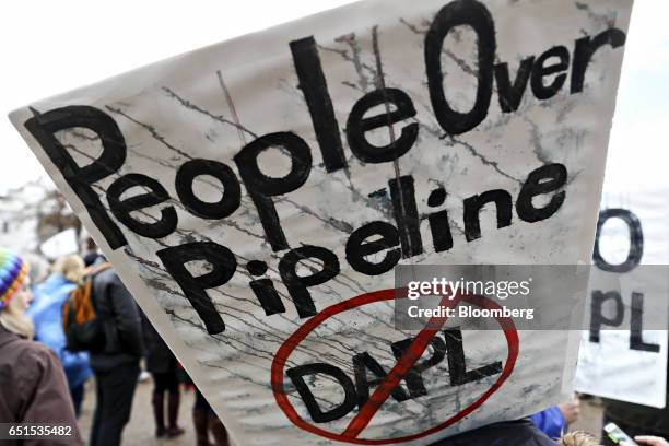 Demonstrator holds a "People Over Pipeline" sign during a protest against the Dakota Access Pipeline in Washington, D.C., U.S., on Friday, March 10,...